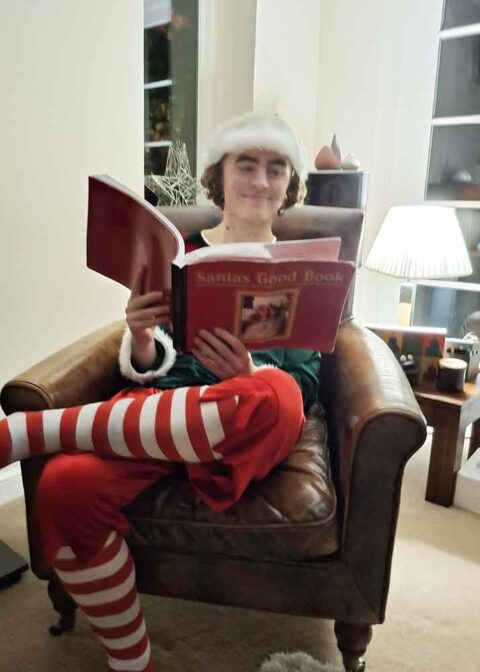 Elf with Santa's good book