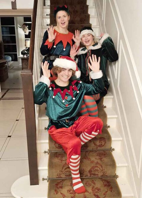 Happy Christmas elves on stairs