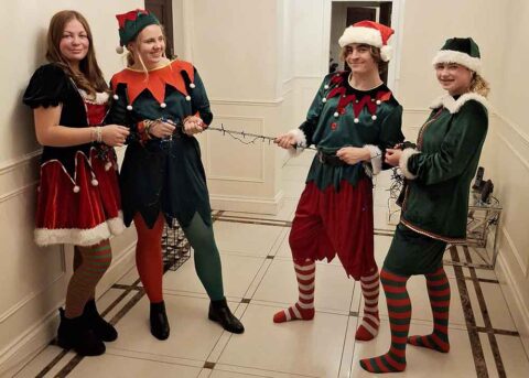Four happy elves in hallway